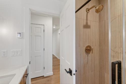 a bathroom with a shower with a wooden door at Maevebrook in Sister Bay