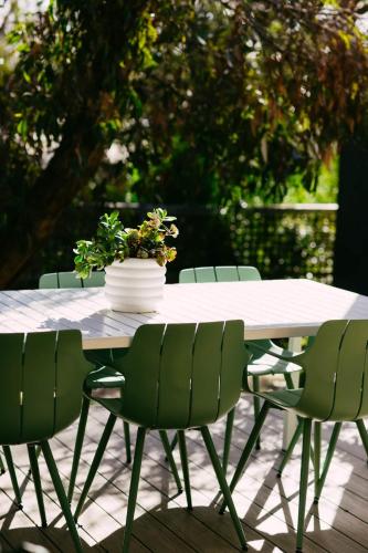 a table with chairs and a potted plant on it at Perfect Beachside Escape - Walk Everywhere in Anglesea