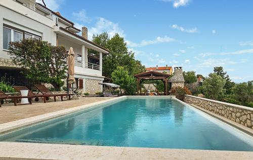 a swimming pool in the backyard of a house at Studio Apartment In Labin in Labin