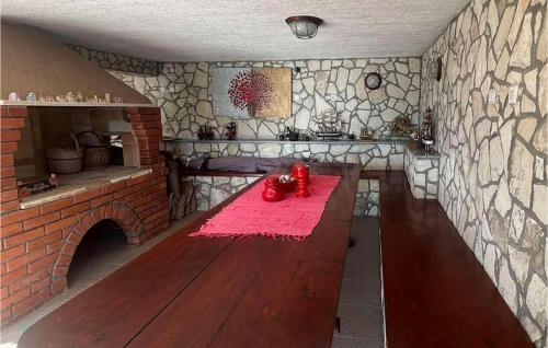a kitchen with a table and a brick wall at Studio Apartment In Labin in Labin