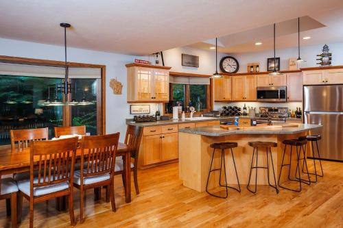 a kitchen with wooden cabinets and a table and chairs at Asher Manor by Simple Life Rentals in Egg Harbor
