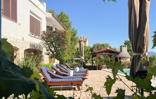 a row of chaise lounges on a patio at Apartment Labin Ravni in Labin