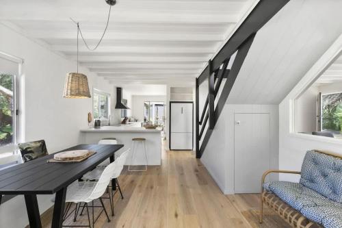 a dining room and kitchen with a table and chairs at Beach at Your Doorstep - Pet Friendly in Anglesea