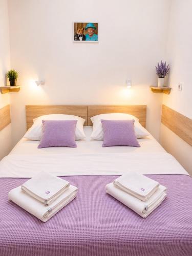 a bedroom with a bed with two towels on it at Svit home Hamster 007- apart-hotel in Lviv