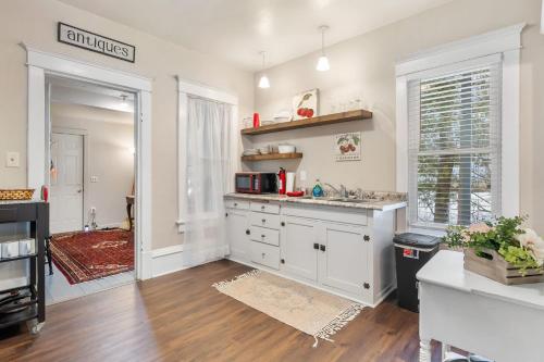a kitchen with white cabinets and a counter top at Stowaway Lower Deck in Sturgeon Bay