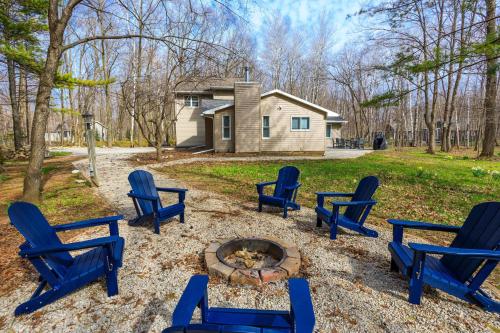a group of blue chairs sitting around a fire pit at Grateful Roots in Egg Harbor