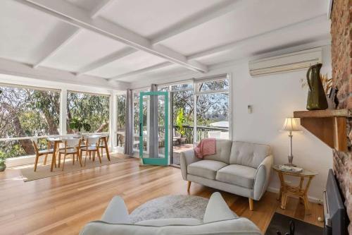 a living room with a couch and a table at Sunny Coastal Retreat in Anglesea