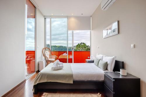a bedroom with a large bed and a large window at Keam House in Santana