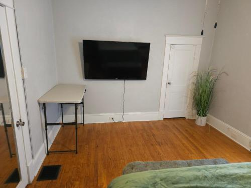 a living room with a flat screen tv on a wall at Huge 4-Bedroom Historic Home & Game Room in Goldsboro