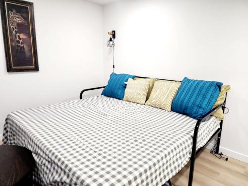 a bed with pillows on it in a room at Edmonton Basement 1 KB 1 SB 3 Guest in Edmonton