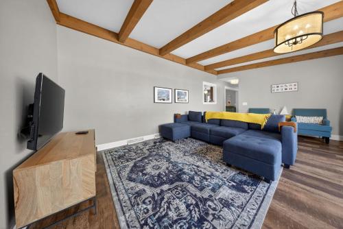 a living room with a blue couch and a tv at High Garden by Simple Life Rentals in Sister Bay