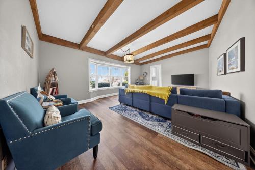 a living room with two blue couches and a tv at High Garden by Simple Life Rentals in Sister Bay