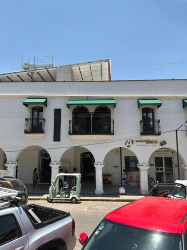 a building with a golf cart parked in front of it at Hotel Boutique Casa Gopar in Ocotlán de Morelos