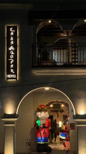a store with a display of a snowman in front of a building at Hotel Boutique Casa Gopar in Ocotlán de Morelos