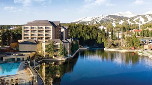 a view of a hotel and a lake with mountains at Mountain Valley Lodge Resort Studio Villa in Breckenridge