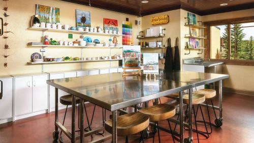 a kitchen with a large table and stools at Mountain Valley Lodge Resort Studio Villa in Breckenridge