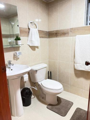 a bathroom with a toilet and a sink at Comfort Home in La Cana
