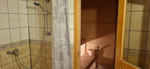 a shower in a bathroom with a staircase at Sinilille 5 Holiday Home in Kuressaare