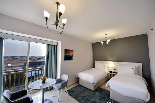 Postel nebo postele na pokoji v ubytování Jannah Hotel Apartments & Villas