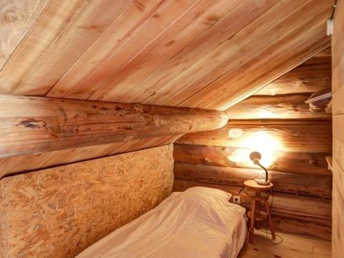 a bedroom with a bed in a wooden cabin at Chalet chaud, nature sauvage, internet PC, idéal randonnées - FR-1-496-184 in Saint-Martin-la-Sauveté