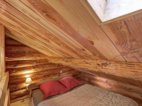 a bedroom in a log cabin with a bed in it at Chalet rustique avec poêle à bois - 3 pers, animaux admis - FR-1-496-187 in Saint-Martin-la-Sauveté