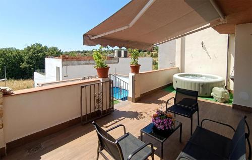 a patio with chairs and a hot tub on a balcony at Taurus 13 in Jun
