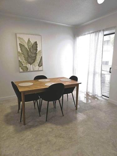 a table in a room with chairs around it at Apartment on The Strand - 2 Bed 2 Bath in North Ward
