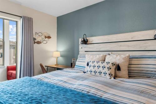 a bedroom with a blue bed with a wooden headboard at Emerald Bay Escape with Sunroom in Hollister