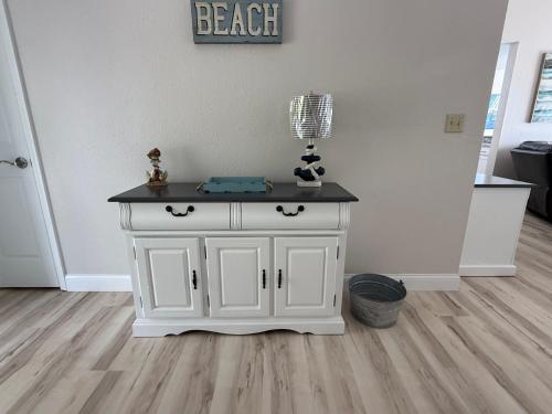 a white cabinet with a black top in a room at Spacious Lakeview Condo with 3 BR3 BA and Pool in Lake Ozark