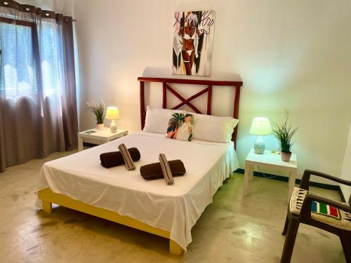 a bedroom with a bed with two towels on it at Villa KAMBUSA in Las Galeras