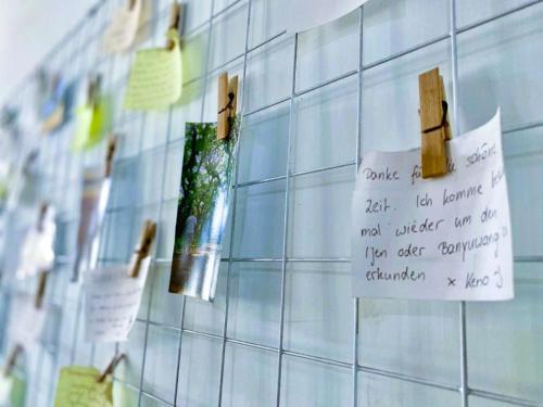 a note is hanging on a tiled wall at Zzz Ijen Hostel in Banyuwangi