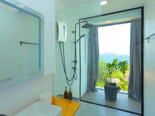 a bathroom with a shower and a large window at Sky Sakad Sunset at Doi Sakad, Nan in Ban Pha Hu