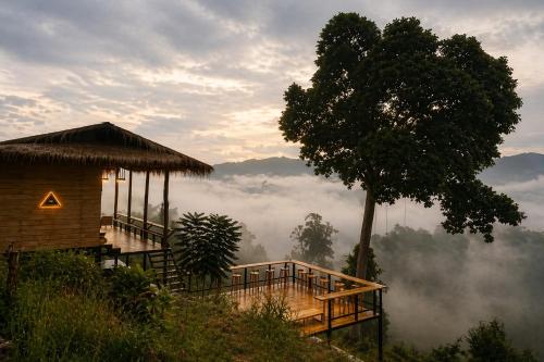 a house on a hill with a tree in the background at 4sky in Ban Kai Noi
