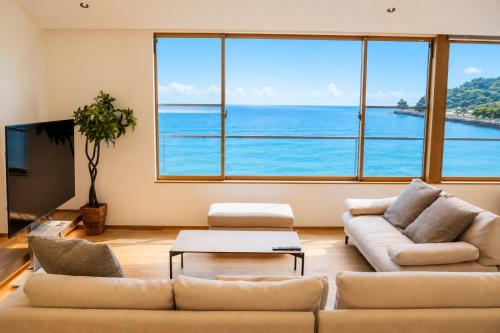 a living room with a view of the ocean at Villa JacoO 2 in Sanuki