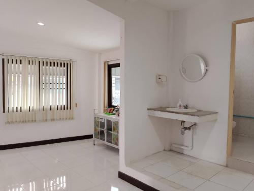 a white bathroom with a sink and a mirror at Jr - House 2 34-103 in Ban Talat Rangsit
