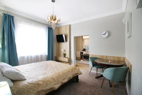 a bedroom with a bed and a desk and a table at La Casa in Sibiu