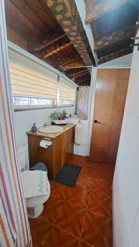 a bathroom with a toilet and a sink at Hostal Boutique CUMBRES in Farellones