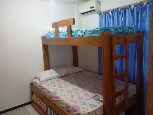 a bedroom with two bunk beds in a room at Hospedaje Meriland in Guayabal