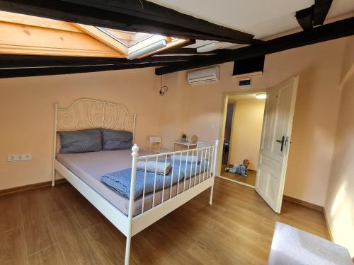 a bedroom with a bed and a baby in a room at XAH - HAN Plovdiv Center in Plovdiv