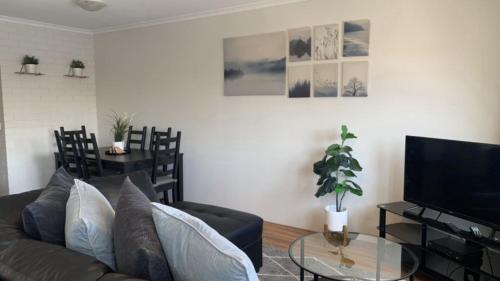 a living room with a couch and a table at Beachside Court Unit 9 in Caloundra