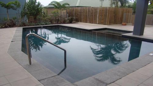 a swimming pool with a reflection of a bird in the water at Unit 33 Outlook Caloundra - Stunning Views! in Caloundra