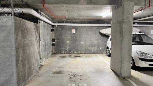 a parking garage with a white car parked in it at Unit 33 Outlook Caloundra - Stunning Views! in Caloundra