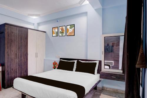 a bedroom with a large bed and a window at Hotel O Satara Bypass Formerly Sairaj Lodging in Satara