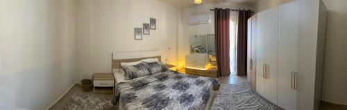 a bedroom with a bed and a bathroom with a sink at بانوراما in Zāwiyat ‘Abd al Mun‘im