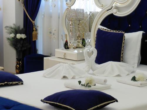 a bedroom with a bed with blue and white at Hotel Dalia - Bankya in Bankya