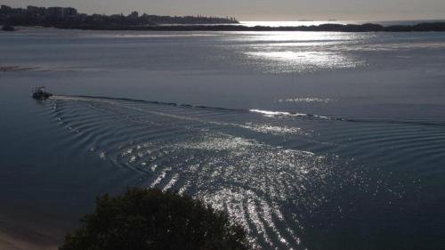 a body of water with a boat in the water at Riviere Unit 718 in Golden Beach