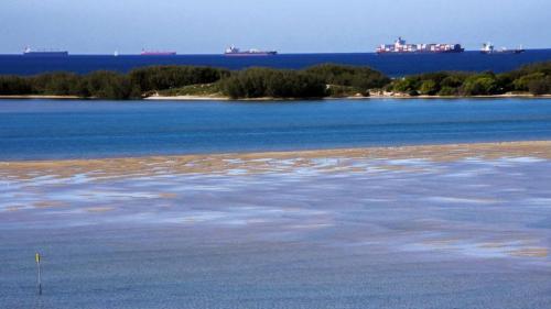 a large body of water with trees and ships in the distance at Riviere Unit 718 in Golden Beach