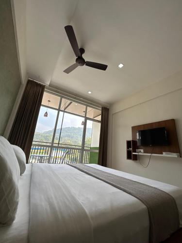 a bedroom with a bed and a window with a view at Dreamwagon hotel lakkidi in Vythiri