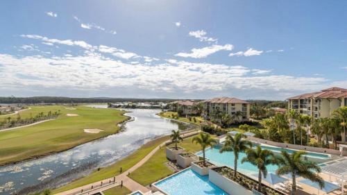an aerial view of a resort with a river at Lovely Studio Apartment Overlooking Golf Course! in Pelican Waters