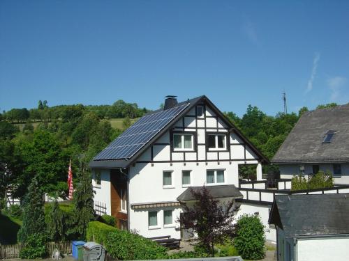 a black and white house with a solar roof at Apartment in Assinghausen with a Sun Terrace in Assinghausen